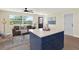A view of the living area including the eat-in kitchen with a blue island at 6220 Pershing Ne St, St Petersburg, FL 33702