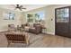 Comfortable living room with modern decor, fan, and a view to the front yard at 6220 Pershing Ne St, St Petersburg, FL 33702
