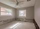 Bright bedroom featuring neutral walls, a ceiling fan and an expansive window at 647 74Th N Ave, St Petersburg, FL 33702