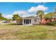 Attractive single-story home with a well-maintained lawn and bright blue front door at 647 74Th N Ave, St Petersburg, FL 33702