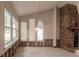 Living room featuring a stone fireplace and large windows at 647 74Th N Ave, St Petersburg, FL 33702