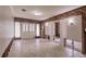 Bright living room with tile flooring, wood paneling, and a double door entrance at 647 74Th N Ave, St Petersburg, FL 33702