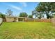 Expansive backyard featuring a large green lawn and a sturdy wooden fence for privacy at 6941 58Th N Way, Pinellas Park, FL 33781