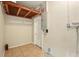 Unfinished basement space with tile flooring, white walls, and a utility door at 6941 58Th N Way, Pinellas Park, FL 33781