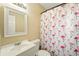 Bathroom featuring a flamingo shower curtain, white vanity, and mirror for a bright, clean space at 6941 58Th N Way, Pinellas Park, FL 33781
