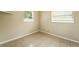 Cozy room with tile floors, two windows, and neutral walls for versatile decorating at 6941 58Th N Way, Pinellas Park, FL 33781