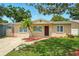 Charming single-story home with lush green lawn and a palm tree in the front yard at 6941 58Th N Way, Pinellas Park, FL 33781
