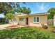 Well-maintained home featuring a green lawn, landscaped flowerbeds, and a quaint walkway at 6941 58Th N Way, Pinellas Park, FL 33781