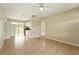 Open living room showcasing ceramic tile floors, a ceiling fan, and kitchen access at 6941 58Th N Way, Pinellas Park, FL 33781