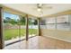 Sun room with tile flooring, ceiling fan, and large glass windows overlooking the backyard at 6941 58Th N Way, Pinellas Park, FL 33781