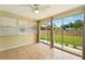 Sun room featuring tile floors, ceiling fan, and access to backyard at 6941 58Th N Way, Pinellas Park, FL 33781