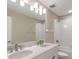 Well-lit bathroom with double vanity, quartz countertop, and a tub-shower combination at 7276 Notched Pine Bnd, Wesley Chapel, FL 33545