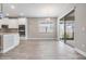 Dining area with wood-look tile, modern chandelier, next to kitchen and access to the backyard at 7276 Notched Pine Bnd, Wesley Chapel, FL 33545