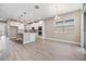 Dining room featuring gray walls, wood-look tile flooring, and sliding glass doors to the backyard at 7276 Notched Pine Bnd, Wesley Chapel, FL 33545