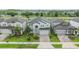 Overhead shot of a home featuring professional landscaping, a paver driveway, and stone accents at 7276 Notched Pine Bnd, Wesley Chapel, FL 33545