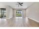 Bright living room featuring sliding glass doors leading to a backyard at 7276 Notched Pine Bnd, Wesley Chapel, FL 33545