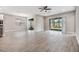Large living area with views of a backyard and access to a screened patio at 7276 Notched Pine Bnd, Wesley Chapel, FL 33545