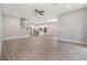 Open living area with wood-look tile flooring throughout and great flow to kitchen at 7276 Notched Pine Bnd, Wesley Chapel, FL 33545
