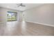 Well-lit living room with sliding glass doors providing backyard views at 7276 Notched Pine Bnd, Wesley Chapel, FL 33545