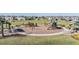 Community playground featuring slides, swings, and covered picnic areas surrounded by green space at 7276 Notched Pine Bnd, Wesley Chapel, FL 33545