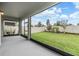 A screened patio offers an inviting view of the home's fenced backyard with a lush lawn at 7276 Notched Pine Bnd, Wesley Chapel, FL 33545