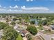 An aerial view of a community featuring a lake and lush tree coverage on a bright, sunny day at 7309 Monterey Blvd, Tampa, FL 33625