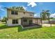 Backyard featuring the home's exterior, screened-in porch, and a green lawn on a sunny day at 7309 Monterey Blvd, Tampa, FL 33625