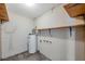 Unfinished basement with concrete block walls, water heater, and wooden shelving at 7309 Monterey Blvd, Tampa, FL 33625