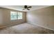 Bright bedroom featuring carpet, ceiling fan and a large window at 7309 Monterey Blvd, Tampa, FL 33625