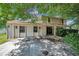 Two-story home featuring a brick and wood exterior with a two car garage and mature trees at 7309 Monterey Blvd, Tampa, FL 33625