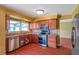 Updated kitchen featuring wood cabinets, stainless steel appliances, and granite countertops at 7309 Monterey Blvd, Tampa, FL 33625