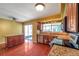 Bright kitchen featuring a stainless steel dishwasher, breakfast bar, and sliding door access to the outdoors at 7309 Monterey Blvd, Tampa, FL 33625