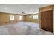 A large living room featuring multiple windows and carpet at 7309 Monterey Blvd, Tampa, FL 33625