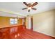 Spacious living room showcasing wood floors, ceiling fan, neutral walls, and natural light at 7309 Monterey Blvd, Tampa, FL 33625
