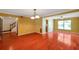 Spacious living room with wood floors, bright walls, and access to other rooms at 7309 Monterey Blvd, Tampa, FL 33625