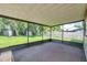 View of a screened-in back porch with a green lawn and mature landscaping just outside at 7309 Monterey Blvd, Tampa, FL 33625