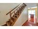 Carpeted stairs with wooden rails leading to another floor with access to the kitchen at 7309 Monterey Blvd, Tampa, FL 33625