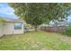 Backyard with a large tree, fence, picnic table and green grass at 8524 Winter Haven Dr, Hudson, FL 34667