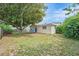 Backyard featuring a large tree, fence and patio with chairs at 8524 Winter Haven Dr, Hudson, FL 34667