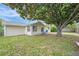 Backyard featuring a large tree, fence and patio with chairs at 8524 Winter Haven Dr, Hudson, FL 34667