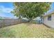 Backyard featuring a large tree, picnic table and wooden fence at 8524 Winter Haven Dr, Hudson, FL 34667