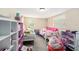 Bedroom with two beds, shelving and a ceiling light at 8524 Winter Haven Dr, Hudson, FL 34667
