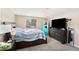 Bedroom with a large bed, shelving, and a window, providing a comfortable retreat at 8524 Winter Haven Dr, Hudson, FL 34667