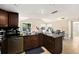 Kitchen featuring dark wood cabinets, black countertops, and tile floors at 8524 Winter Haven Dr, Hudson, FL 34667