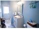 Bathroom featuring a single vanity, decorative mirror, and a tiled shower with an exterior door at 8679 Burning Tree Cir, Seminole, FL 33777