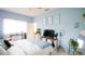 Bright bedroom with blue walls, a large bed, desk, and a decorative plant at 8679 Burning Tree Cir, Seminole, FL 33777