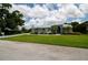 Well-maintained home boasts a lush lawn, elegant landscaping, and a serene ambiance, creating an inviting curb appeal at 8679 Burning Tree Cir, Seminole, FL 33777