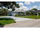 Charming single-story home features a well-manicured lawn, two-car garage, and beautiful landscaping at 8679 Burning Tree Cir, Seminole, FL 33777
