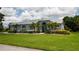Well-maintained home boasts a lush lawn, elegant landscaping, and a serene ambiance, creating an inviting curb appeal at 8679 Burning Tree Cir, Seminole, FL 33777