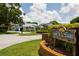 Charming neighborhood entrance with mature landscaping, welcoming residents and guests to Burning Tree Estates community at 8679 Burning Tree Cir, Seminole, FL 33777